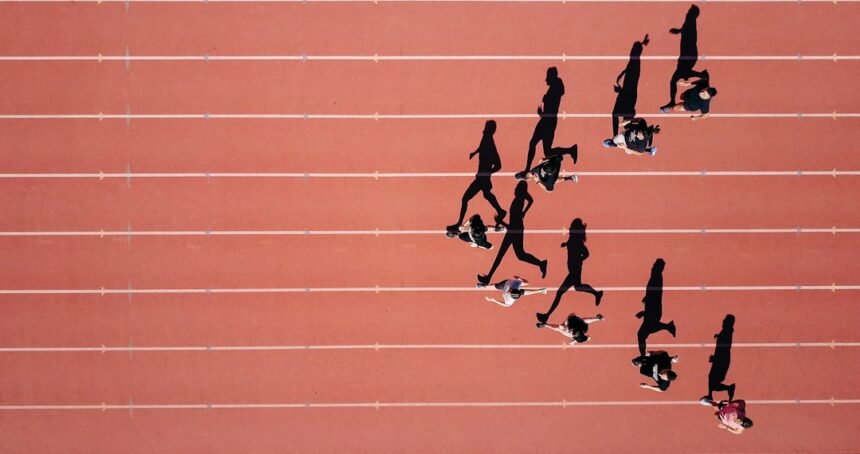 Track athletes running in a stadium