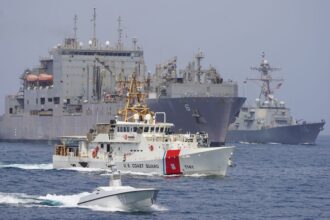 U.S. Navy and Coast Guard vessels transit the Strait of Hormuz in a 2023 file photograph.