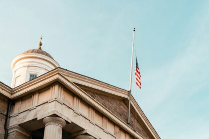 United States courthouse exterior with columns and an American flag