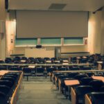 University lecture hall illustrating the University of California’s review of admissions requirements.
