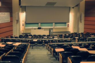University lecture hall illustrating the University of California’s review of admissions requirements.