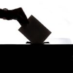 Voter casting a ballot illustrating Newport Beach charter measure litigation