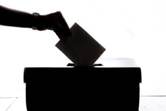 Voter casting a ballot illustrating Newport Beach charter measure litigation