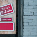 We are hiring sign displayed at a workplace.