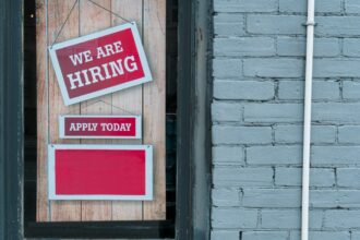 We are hiring sign displayed at a workplace.