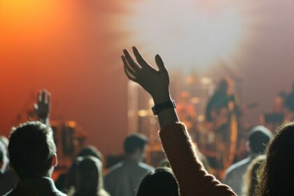 Young adults raising their hands during a worship gathering