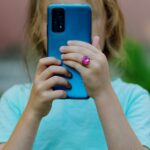 Young girl using a smartphone, illustrating child privacy concerns