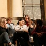 Young people sitting together in conversation as new research examines trust and belonging