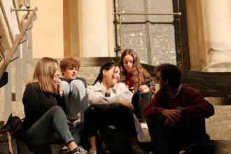 Young people sitting together in conversation as new research examines trust and belonging