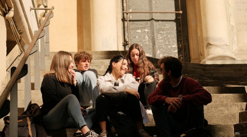 Young people sitting together in conversation as new research examines trust and belonging