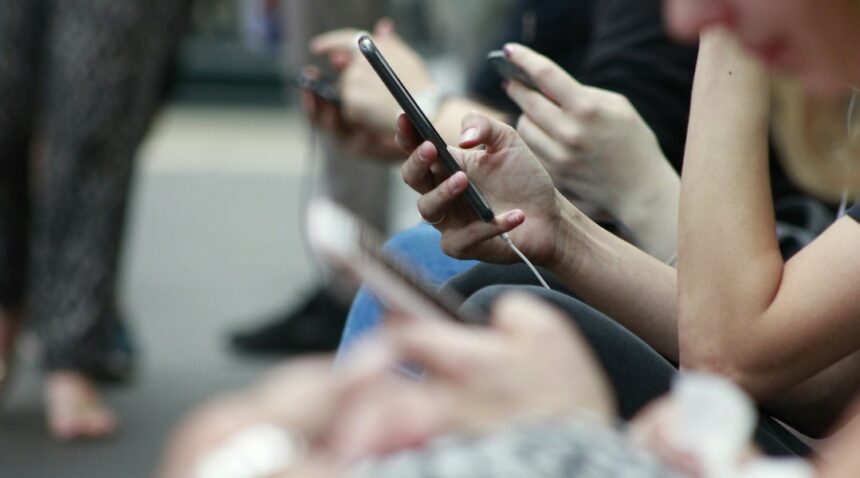 Young person holding a smartphone representing teen social media use