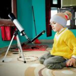 Young student exploring space science with a telescope