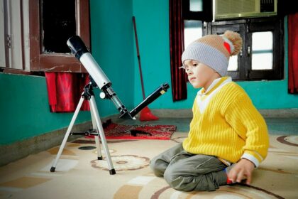 Young student exploring space science with a telescope