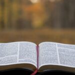 An open Bible on a gray surface. Illustrative photograph.