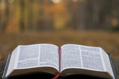 An open Bible on a gray surface. Illustrative photograph.