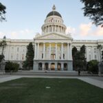 California State Capitol in Sacramento beneath a clear evening sky.