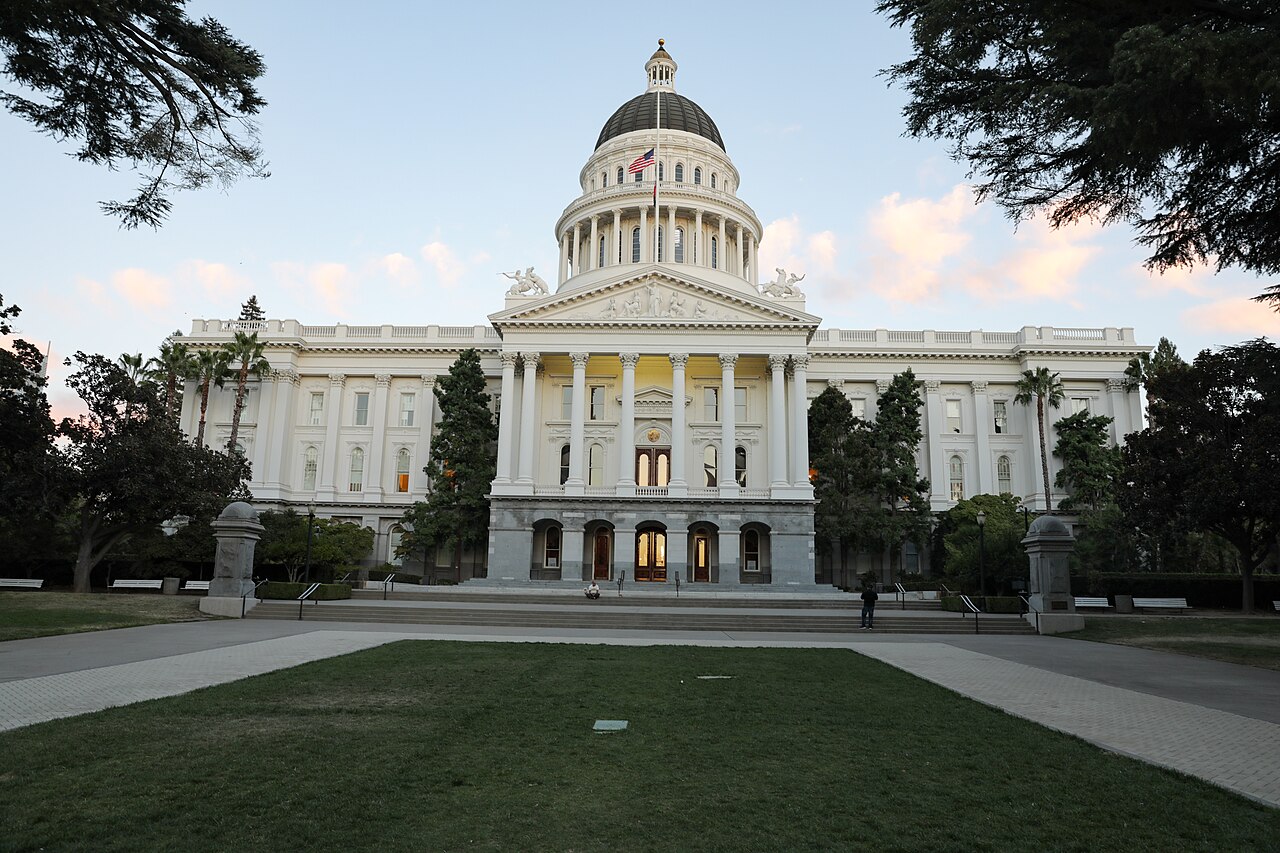 California State Capitol in Sacramento beneath a clear evening sky.