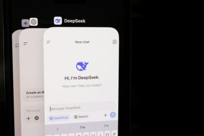 DeepSeek’s interface displayed on a smartphone beside a keyboard.