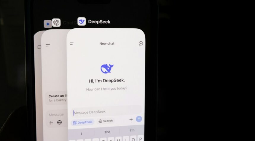 DeepSeek’s interface displayed on a smartphone beside a keyboard.