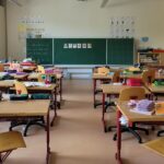 Desks and chairs in a classroom; illustrative photograph