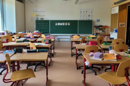Desks and chairs in a classroom; illustrative photograph