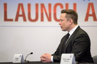 Elon Musk seated at a NASA launch briefing in May 2020.