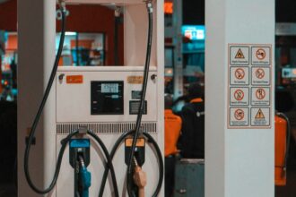 Fuel pump at a gas station at night; illustrative photograph.