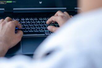 Illustrative photograph of a laptop user; not a participant in the evaluation