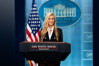 Katie Zacharia at the White House briefing podium on October 13, 2026. Official White House photo by Andrea Hanks.