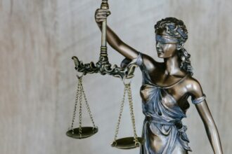 Lady Justice statue, illustrative photograph for a court and police review report