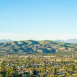 Orange County cityscape with mountains in the distance; regional illustration.