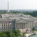 U.S. Treasury building in Washington, D.C., with the Washington Monument in the background, photographed in July 2015.