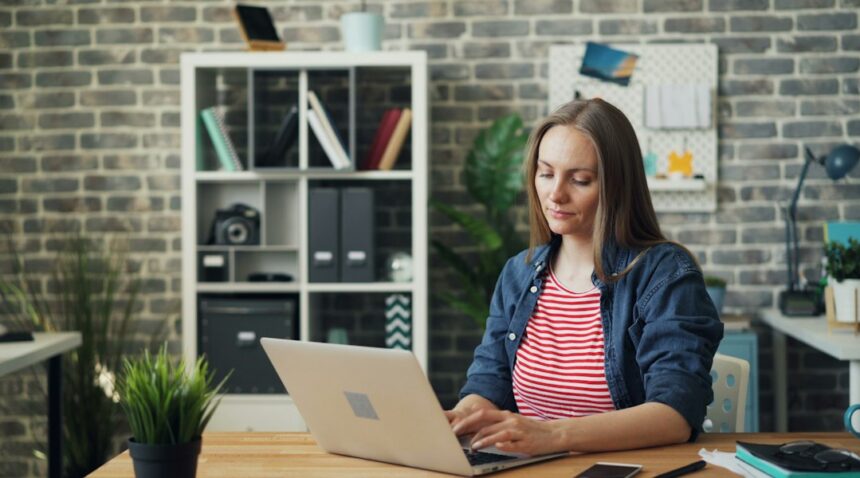 Woman working at a laptop in an office