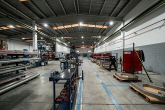 Workers and equipment inside a manufacturing facility