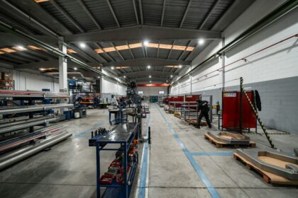 Workers and equipment inside a manufacturing facility